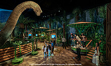 Besucher gehen an einem Langhalsdino entlang